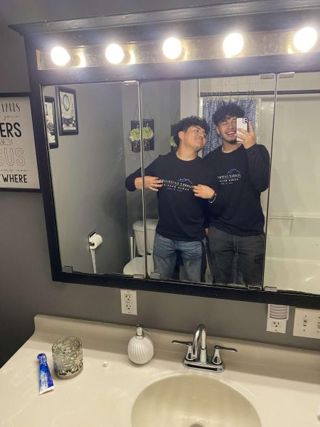 Chris Hernandez (left) and Jose Juarez (right) pose for a mirror picture before work.